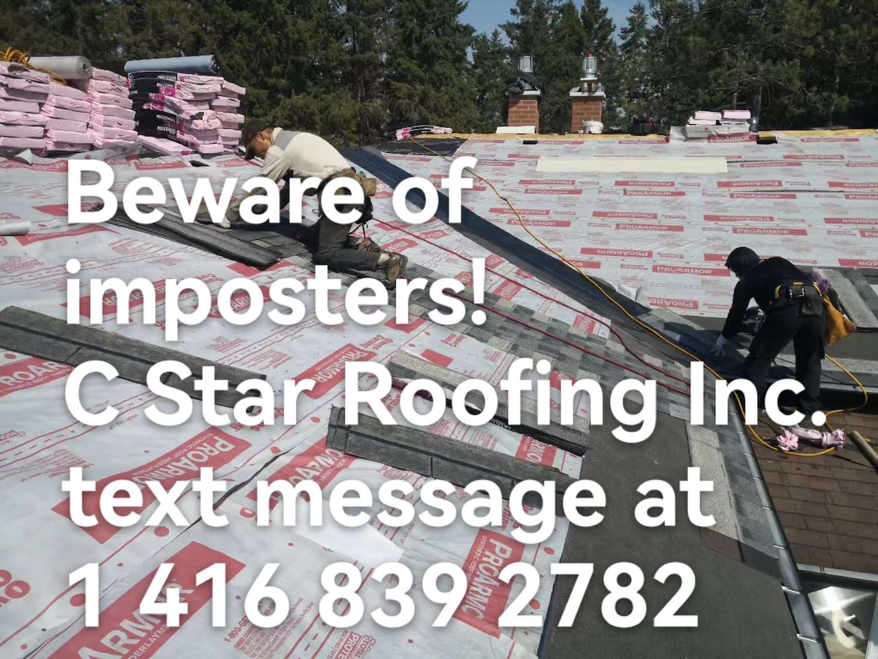 Two roofers installing shingles with material bundles staged on the roof